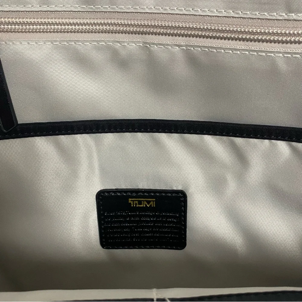 Tumi Black Backpack with Gold Zippers